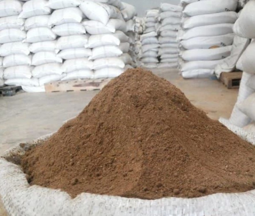 Palm Kernel Cake powder piled in a warehouse